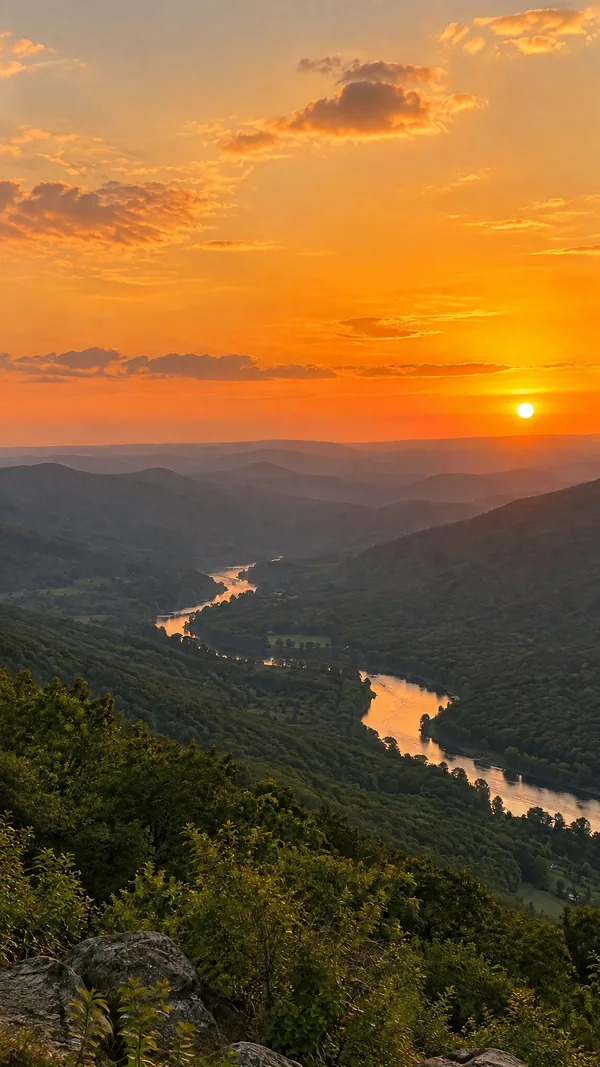 After: the same sunset over the river valley with the power lines and the pole removed