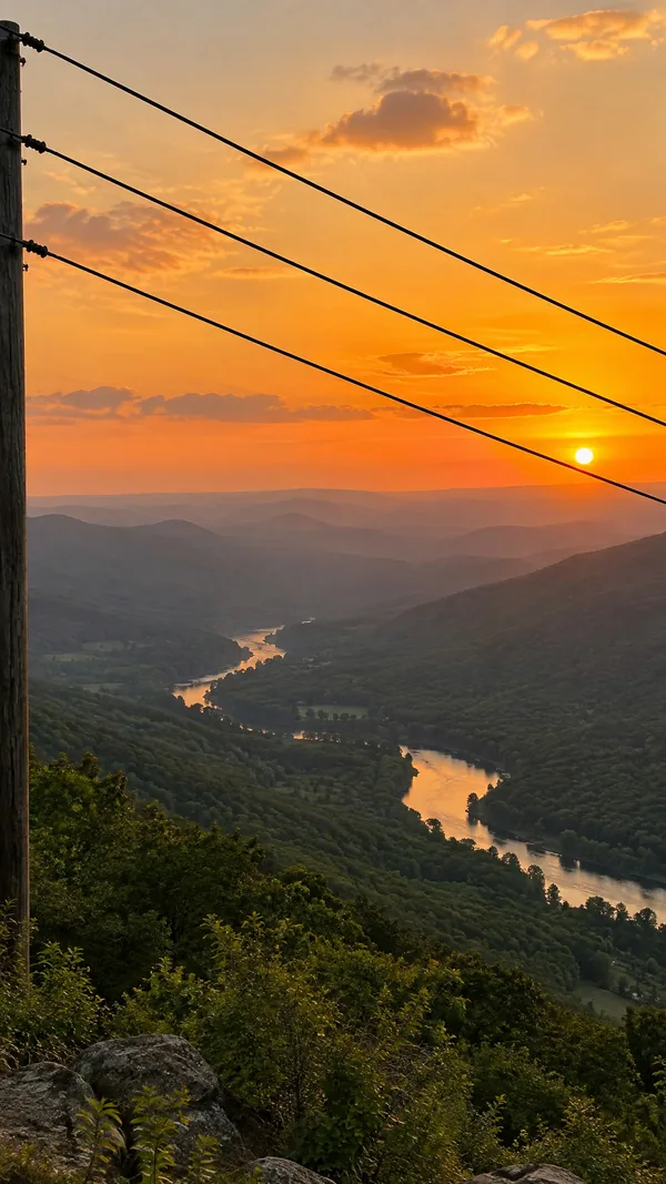 Before: a mountain viewpoint at sunset over a river valley, with power lines and a pole across the sky